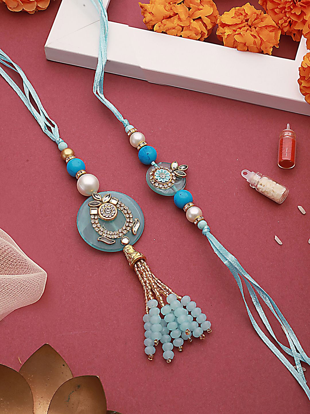 Jazz and Sizzle Crystal Studded & Pearl Tasselled Bhaiya Bhabhi Rakhi With Roli & Chawal, Blue
Jazz and Sizzle Crystal Studded & Pearl Tasselled Bhaiya Bhabhi Rakhi With Roli & Chawal, Blue