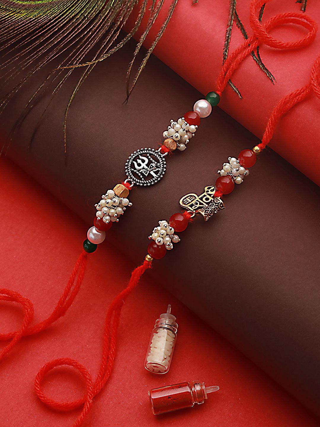 Jazz and Sizzle Set of 2 Trishul & Shiva Dumroo Mogra Beaded Rakhis With Roli & Chawal, Maroon
Jazz and Sizzle Set of 2 Trishul & Shiva Dumroo Mogra Beaded Rakhis With Roli & Chawal, Maroon