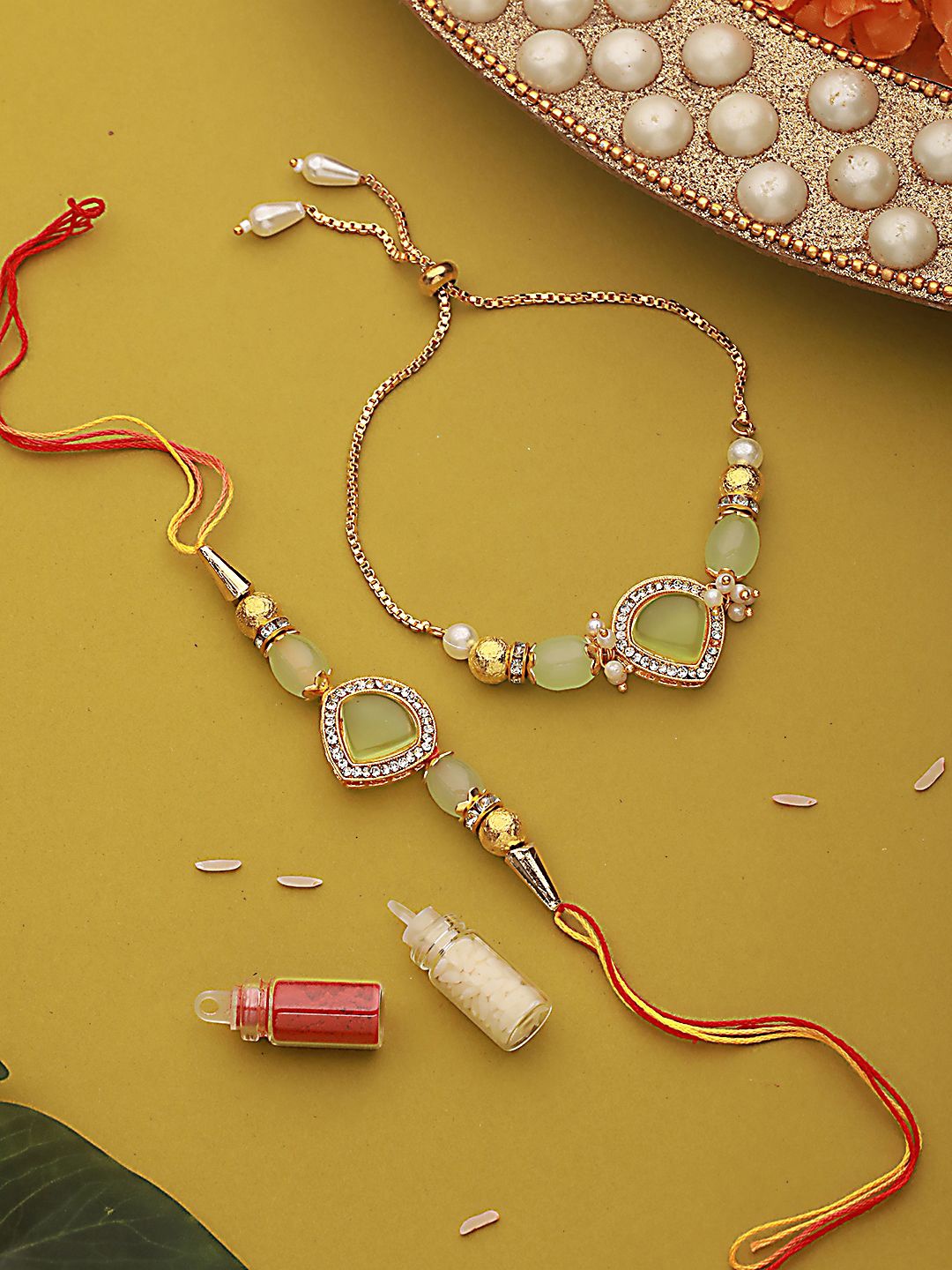 Jazz and Sizzle Stone & CZ Studded Bhaiya Bhabhi Chain Rakhi with Roli & Chawal, Fluorescent green
Jazz and Sizzle Stone & CZ Studded Bhaiya Bhabhi Chain Rakhi with Roli & Chawal, Fluorescent green