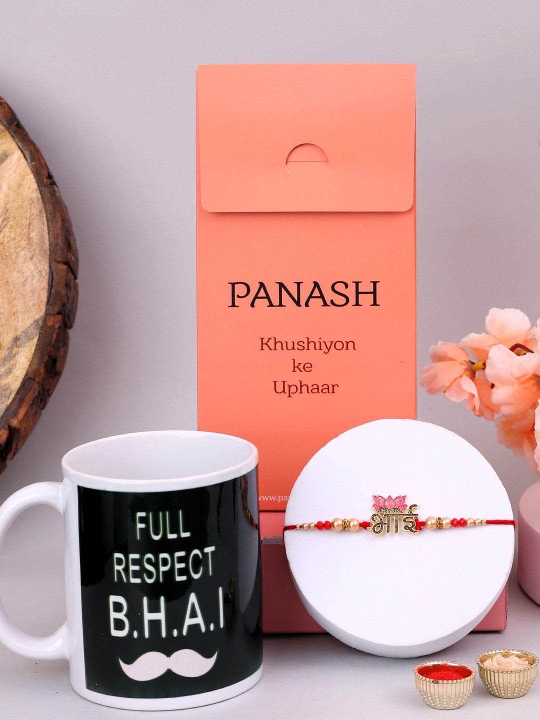 PANASH Set Of 2 Gold Plated Lotus Shaped Thread Rakhis With Printed Mug & Roli Chawal
PANASH Set Of 2 Gold Plated Lotus Shaped Thread Rakhis With Printed Mug & Roli Chawal