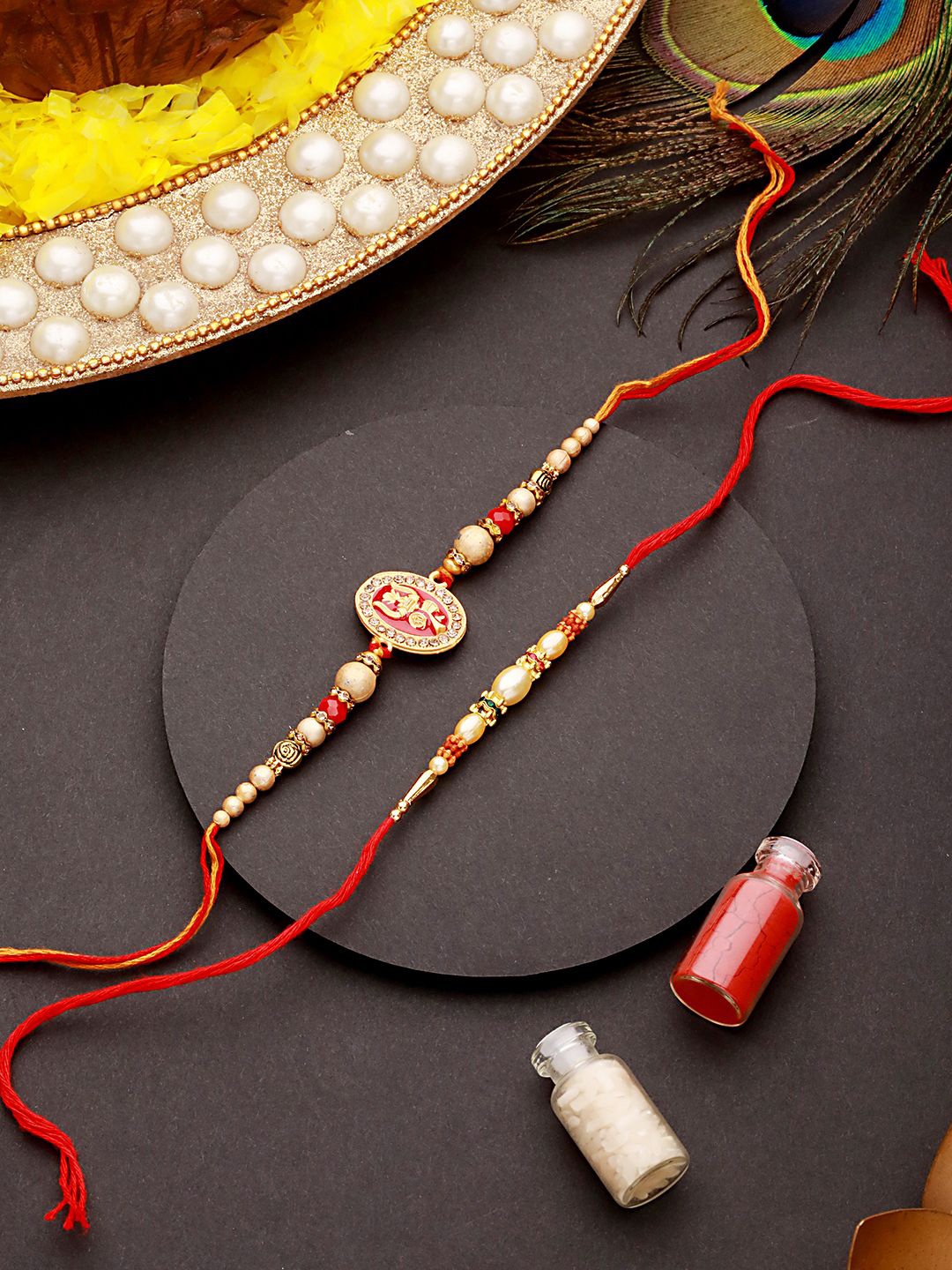 Jazz and Sizzle Set of 2 Trishul Enamelled & Faux Pearl Beaded Rakhi With Roli Chawal, Brown
Jazz and Sizzle Set of 2 Trishul Enamelled & Faux Pearl Beaded Rakhi With Roli Chawal, Brown