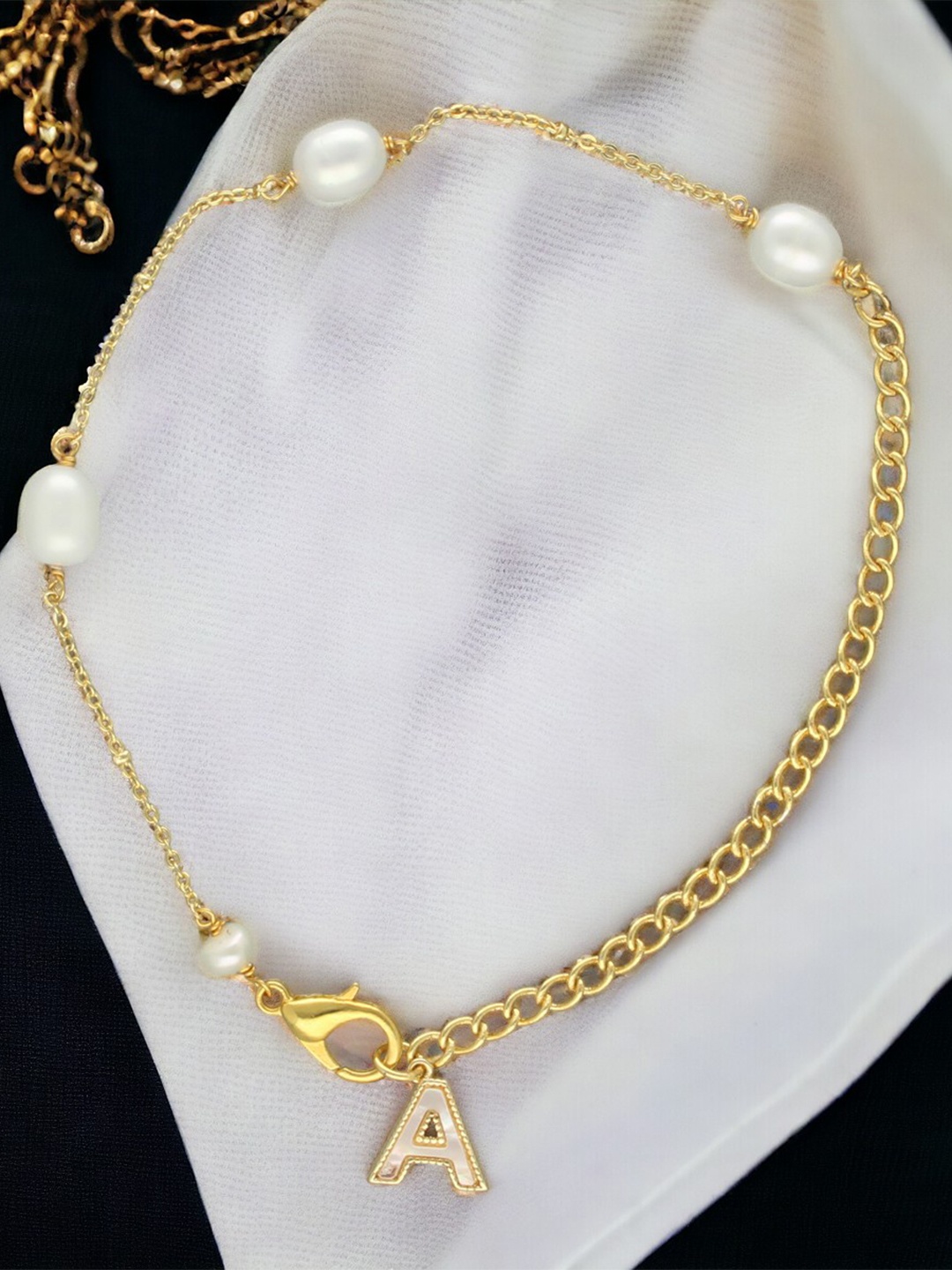Sri Jagdamba Pearls Dealer Gold-Plated Mother of Pearl Studded A Alphabet Charm Bracelet
Sri Jagdamba Pearls Dealer Gold-Plated Mother of Pearl Studded A Alphabet Charm Bracelet