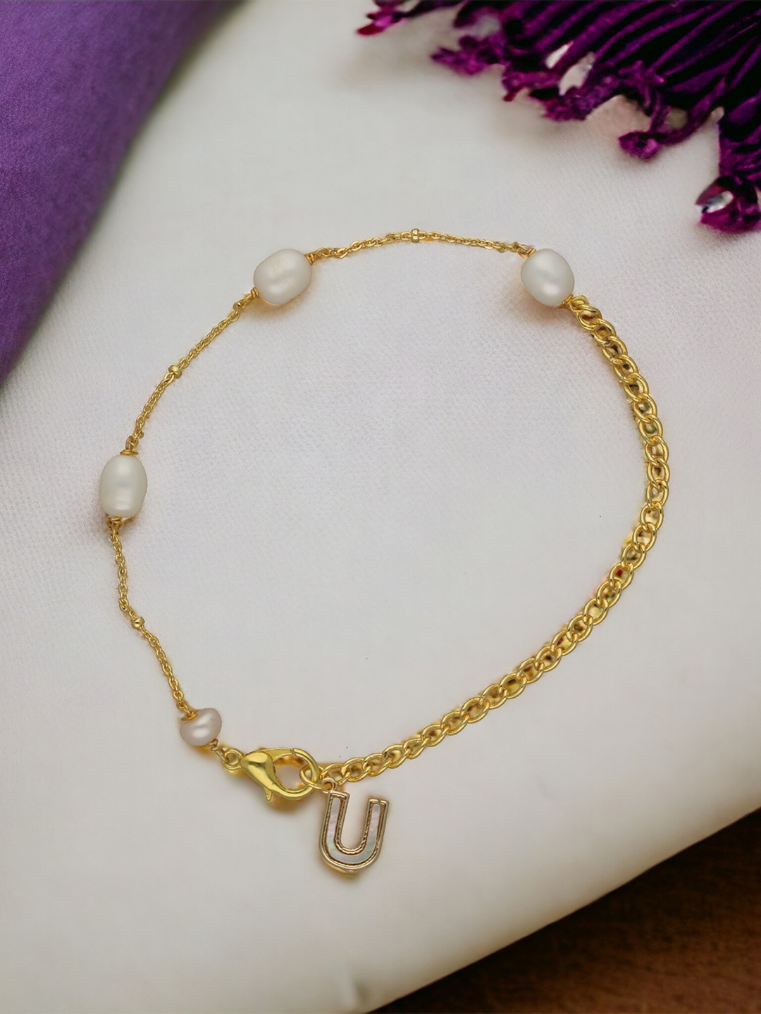 Sri Jagdamba Pearls Dealer Gold-Plated Mother of Pearl Studded U Alphabet Charm Bracelet
Sri Jagdamba Pearls Dealer Gold-Plated Mother of Pearl Studded U Alphabet Charm Bracelet
