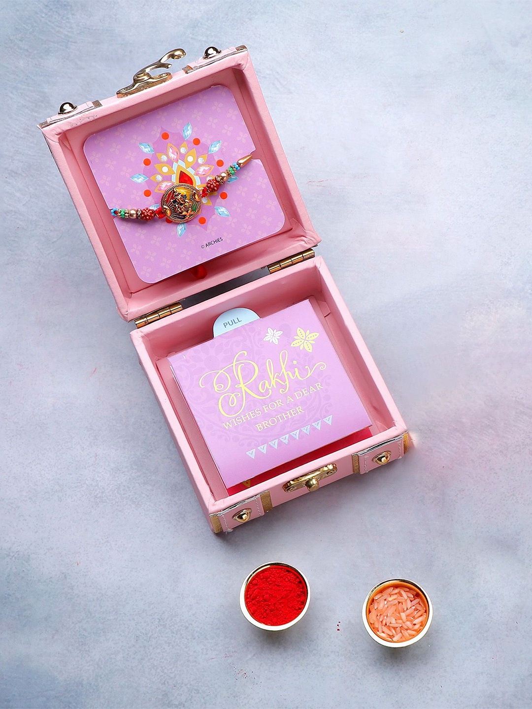 Archies Shree Ganesha Rudraksha Thread Rakhi in Trunk Box With Roli Chawal & Greeting Card, Pink
Archies Shree Ganesha Rudraksha Thread Rakhi in Trunk Box With Roli Chawal & Greeting Card, Pink