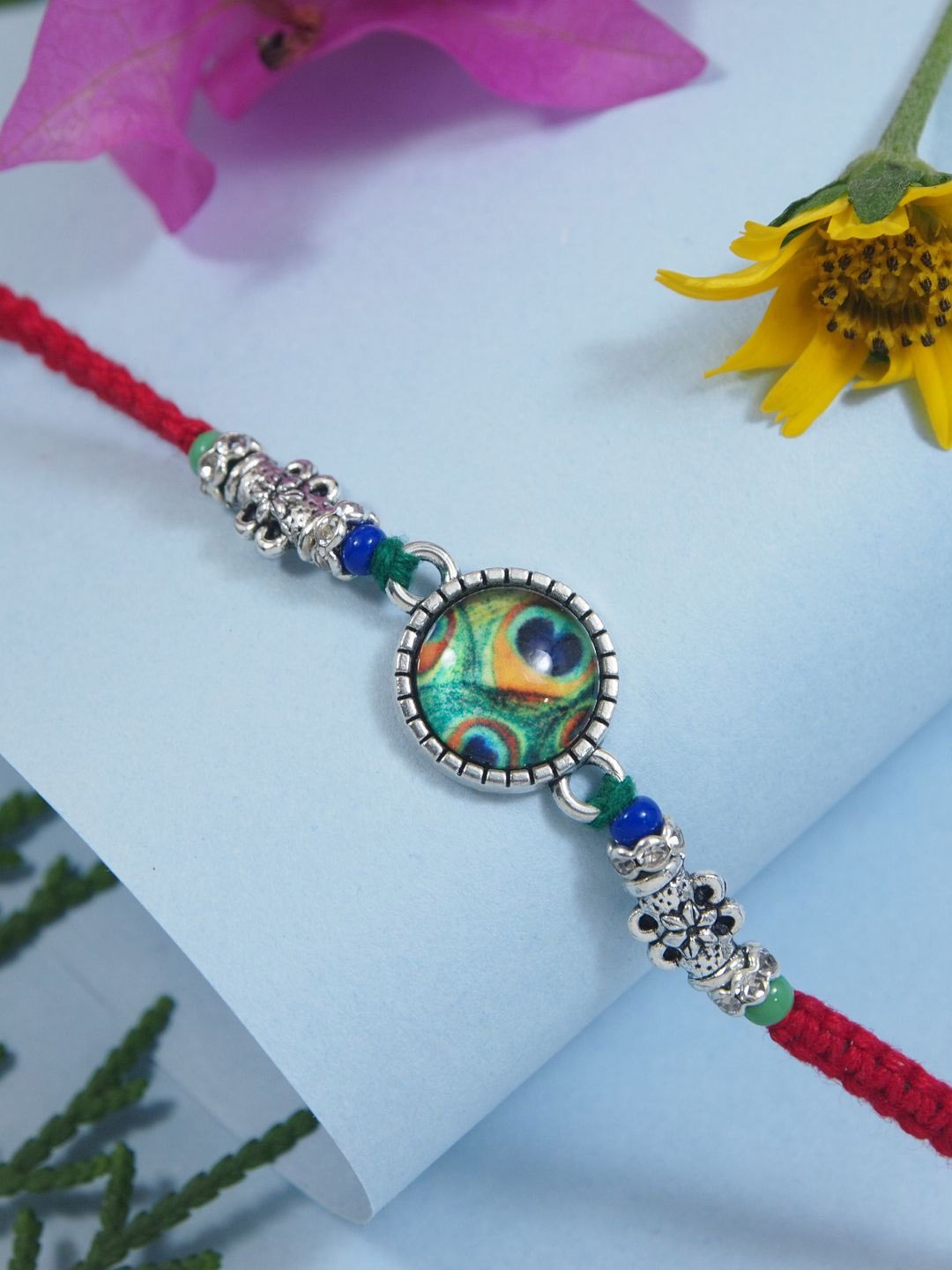 I Jewels Enamel Peacock Pearl Beaded Thread Rakhi With Roli Chawal & Greeting Card, Red
I Jewels Enamel Peacock Pearl Beaded Thread Rakhi With Roli Chawal & Greeting Card, Red