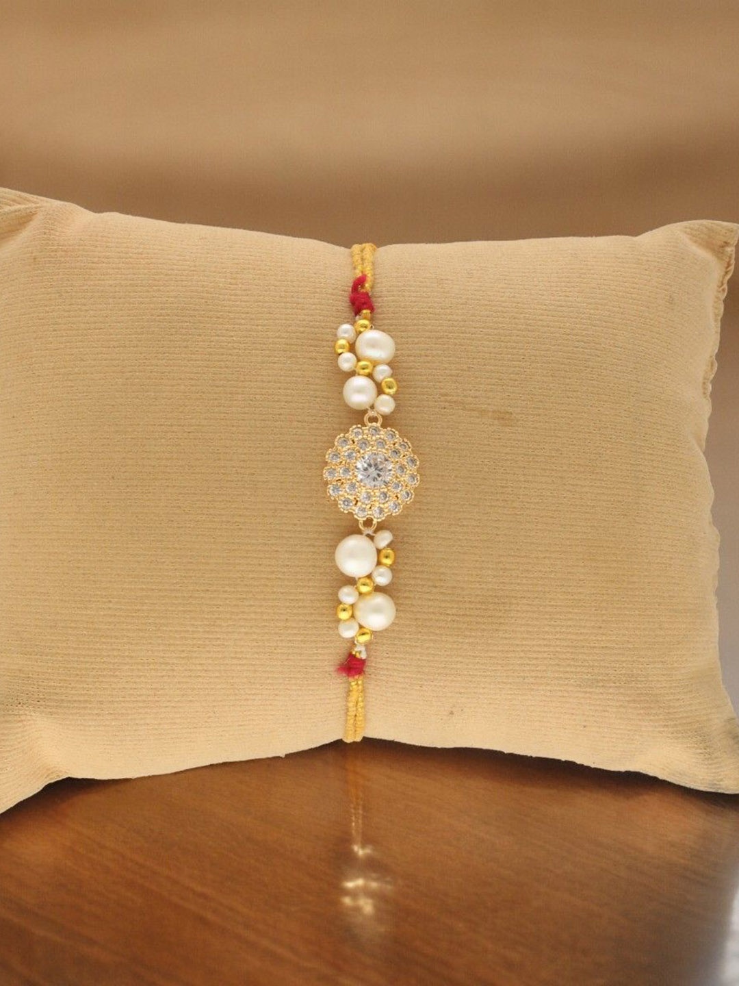 Sri Jagdamba Pearls Dealer Stone Studded Fresh Water Pearl Beaded Thread Rakhi, White
Sri Jagdamba Pearls Dealer Stone Studded Fresh Water Pearl Beaded Thread Rakhi, White