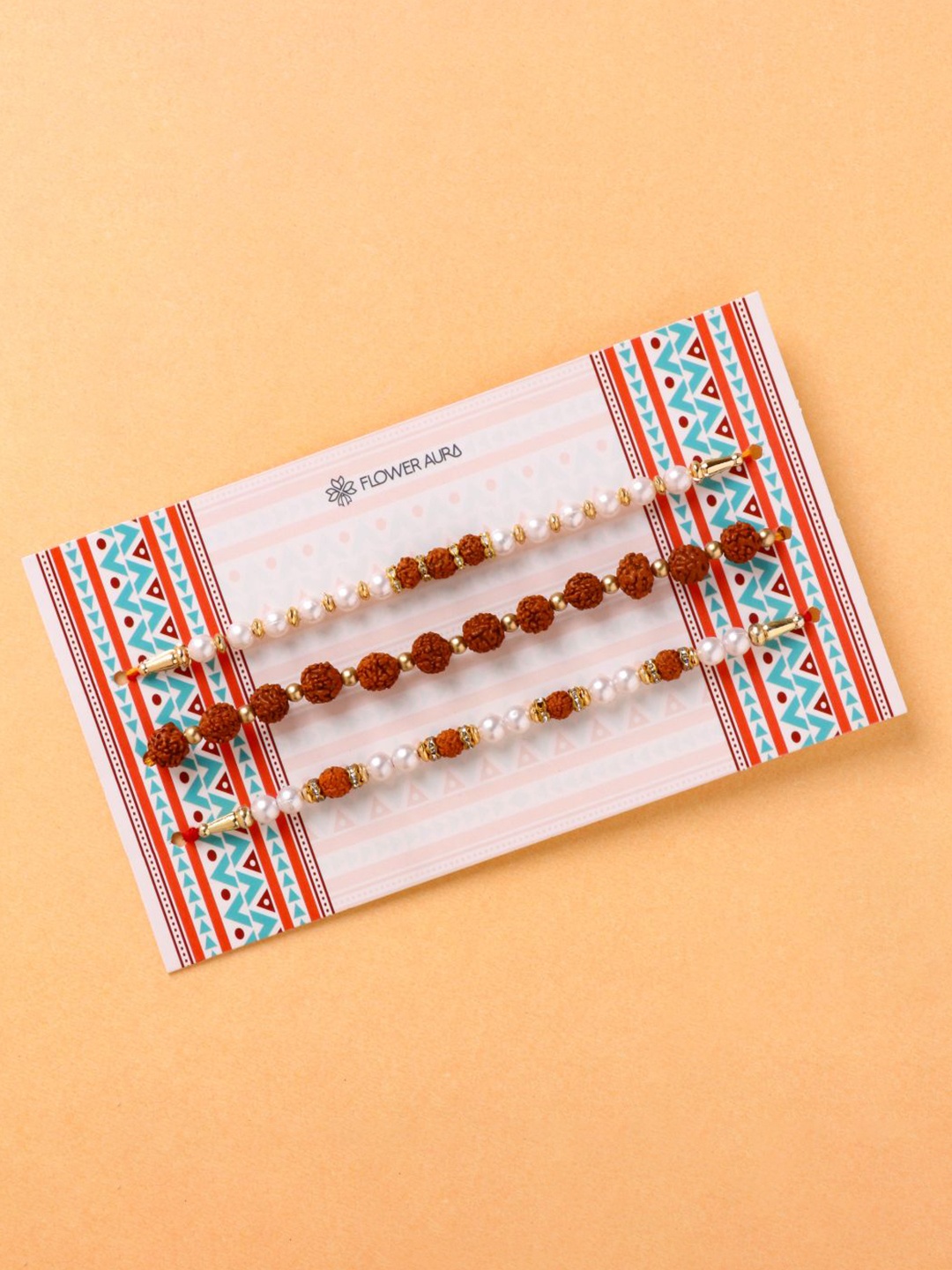 Floweraura Set Of 3 Rudraksha and Pearl Beaded Thread Rakhis With Roli Chawal, Red
Floweraura Set Of 3 Rudraksha and Pearl Beaded Thread Rakhis With Roli Chawal, Red