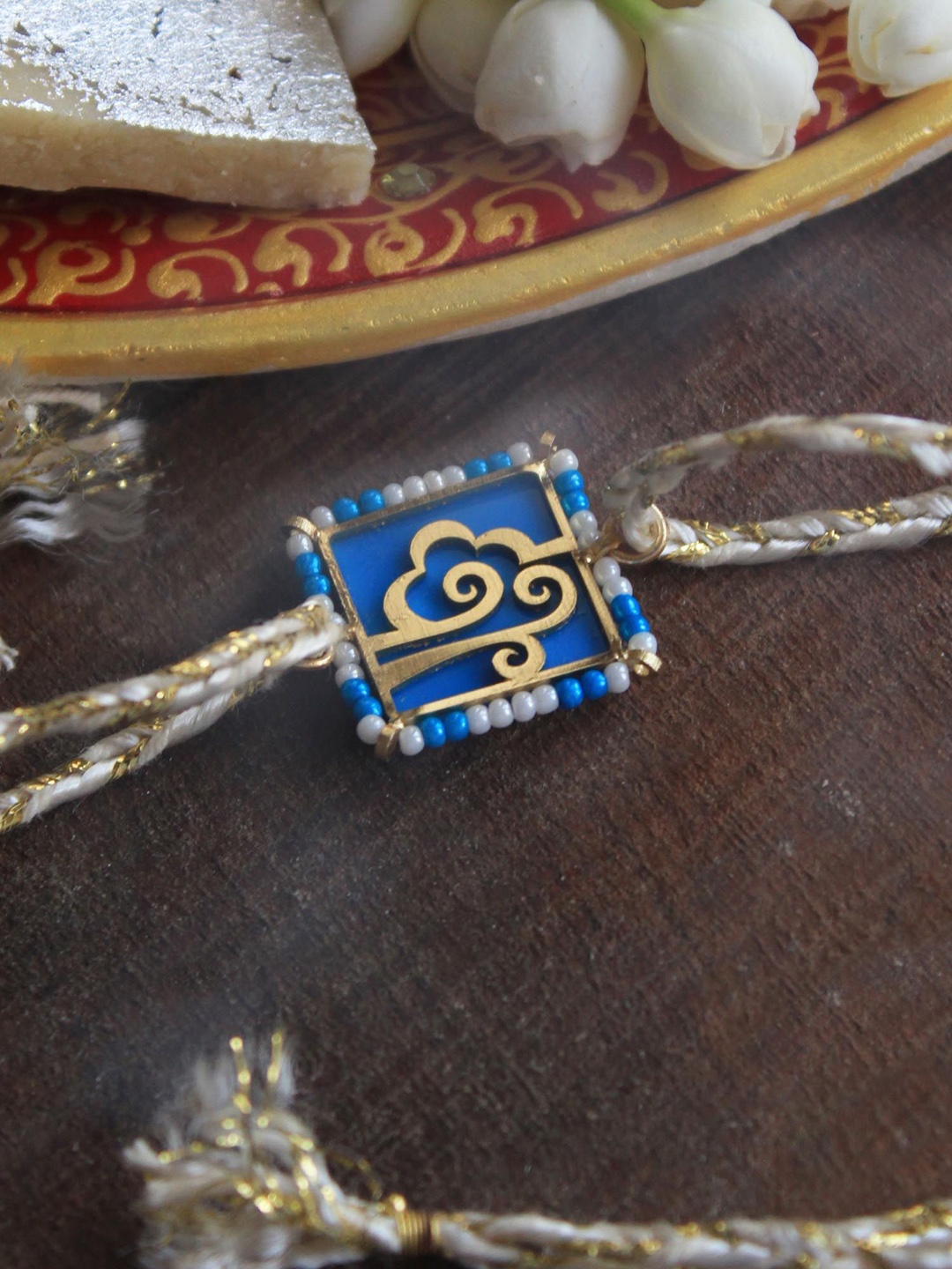 BeAbhika Free Spirited Laser Cut Wind Rakhi With Beaded Border Rakhi & Roli & Chawal, Blue
BeAbhika Free Spirited Laser Cut Wind Rakhi With Beaded Border Rakhi & Roli & Chawal, Blue