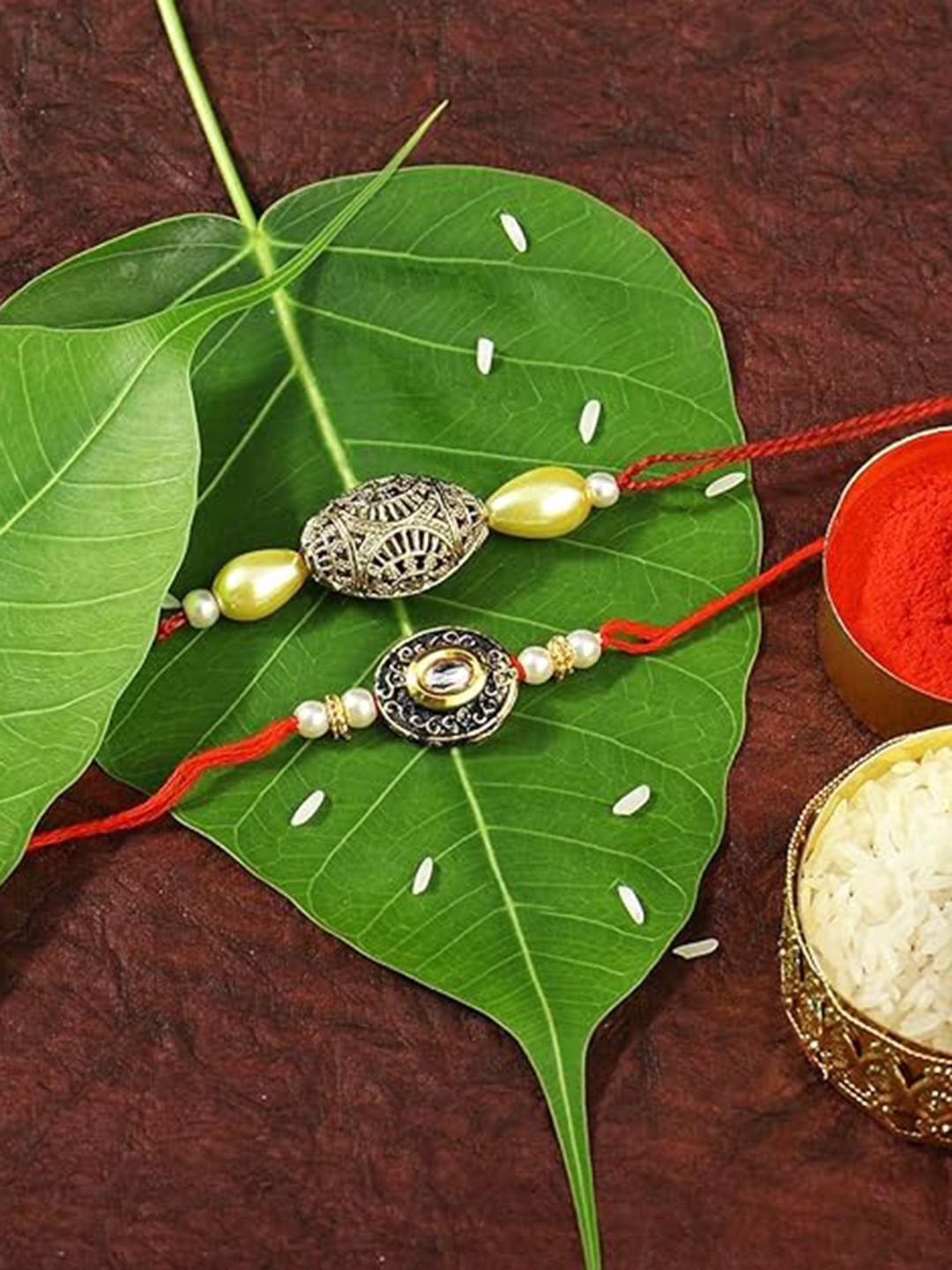 Peora Set of 2 Gold Plated Pearl Kundan Studded Rakhis with Roli Chawal and Greeting Card, Red
Peora Set of 2 Gold Plated Pearl Kundan Studded Rakhis with Roli Chawal and Greeting Card, Red