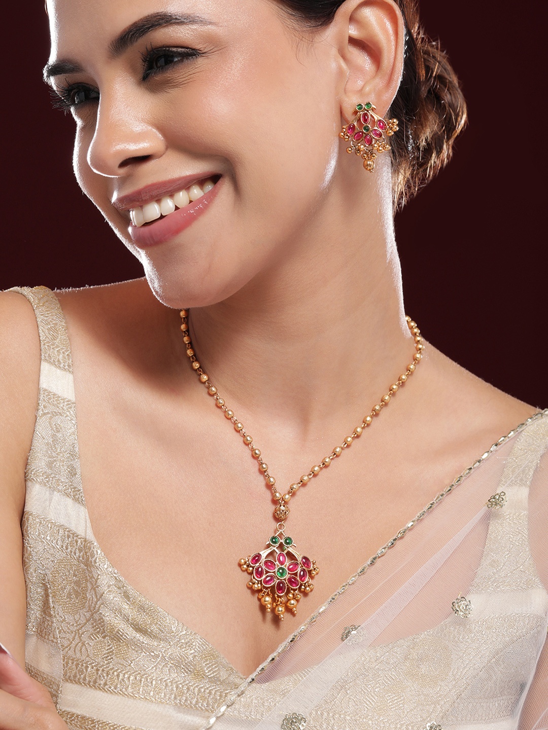 Rubans 22K Gold-Plated Emerald Green, Ruby Pink Kundan Jewellery Set with Golden Beads
Rubans 22K Gold-Plated Emerald Green, Ruby Pink Kundan Jewellery Set with Golden Beads