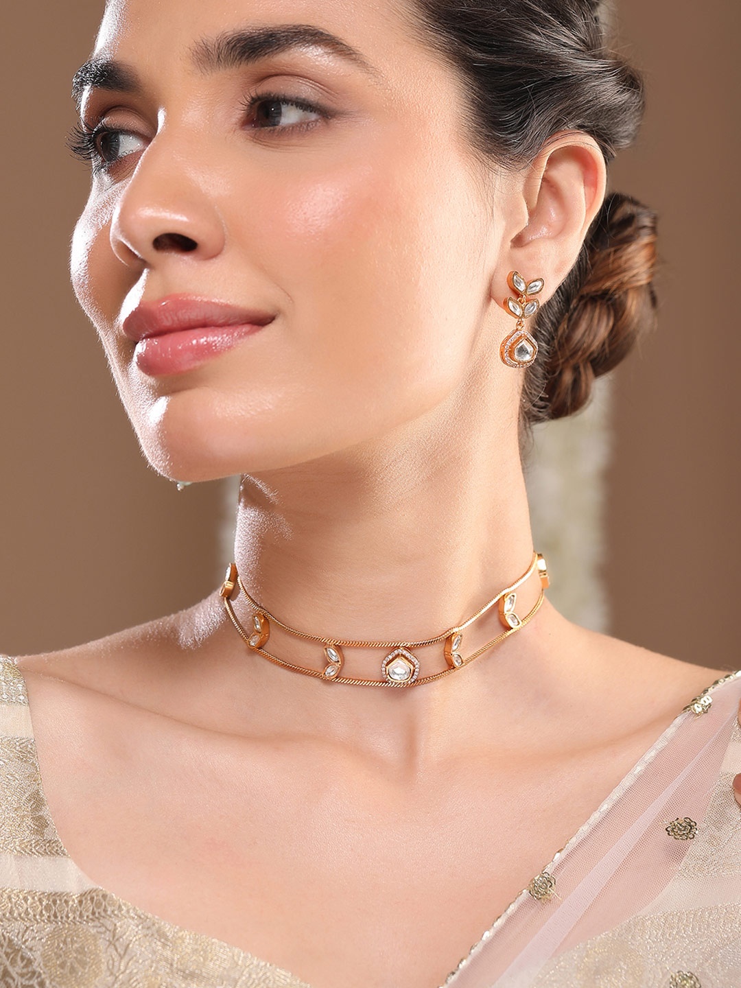 Rubans 24K Gold-Plated White Kundan Studded Minimalist Choker Set with Drop Earrings
Rubans 24K Gold-Plated White Kundan Studded Minimalist Choker Set with Drop Earrings