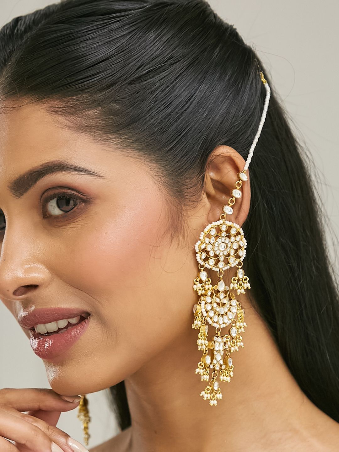 Yinara 22K Gold Plated Kundan Studded & Pearl Beaded Crescent Shaped Kanauti Earrings
Yinara 22K Gold Plated Kundan Studded & Pearl Beaded Crescent Shaped Kanauti Earrings