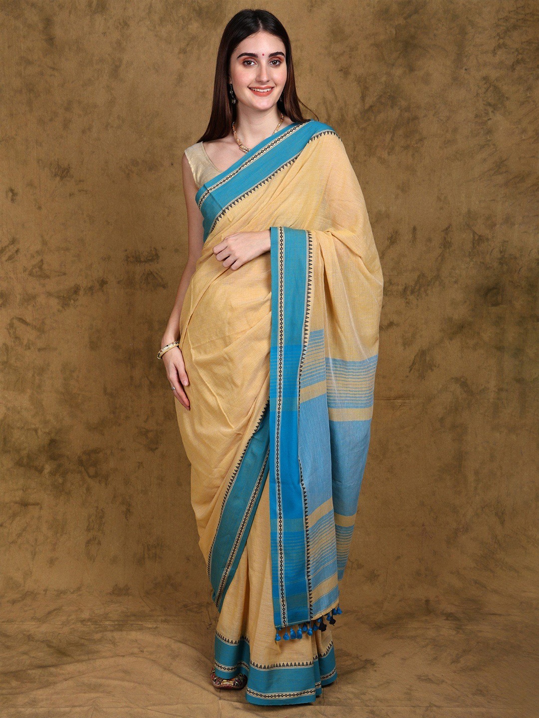 Exotic India Pure Cotton Tangail Saree with Contrast Temple Border and Latkan, Beige
Exotic India Pure Cotton Tangail Saree with Contrast Temple Border and Latkan, Beige
