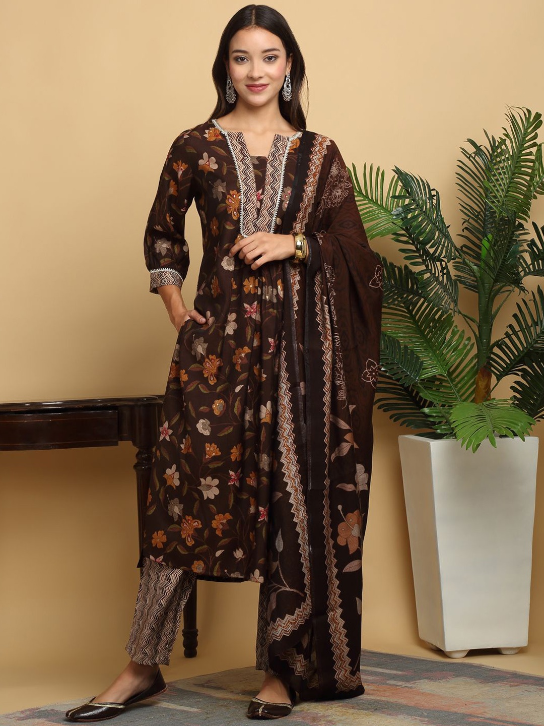 KALINI Floral Printed Notch Neck Modal Chanderi Straight Kurta With Trousers And Dupatta, Brown
KALINI Floral Printed Notch Neck Modal Chanderi Straight Kurta With Trousers And Dupatta, Brown