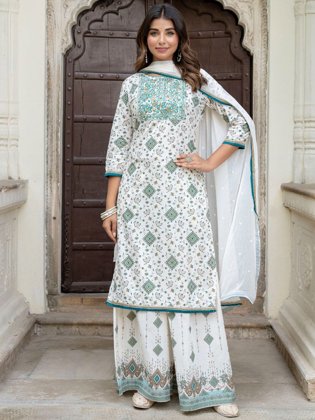 KALINI Women Floral Printed Regular Sequinned Kurta with Sharara & With Dupatta, White
KALINI Women Floral Printed Regular Sequinned Kurta with Sharara & With Dupatta, White