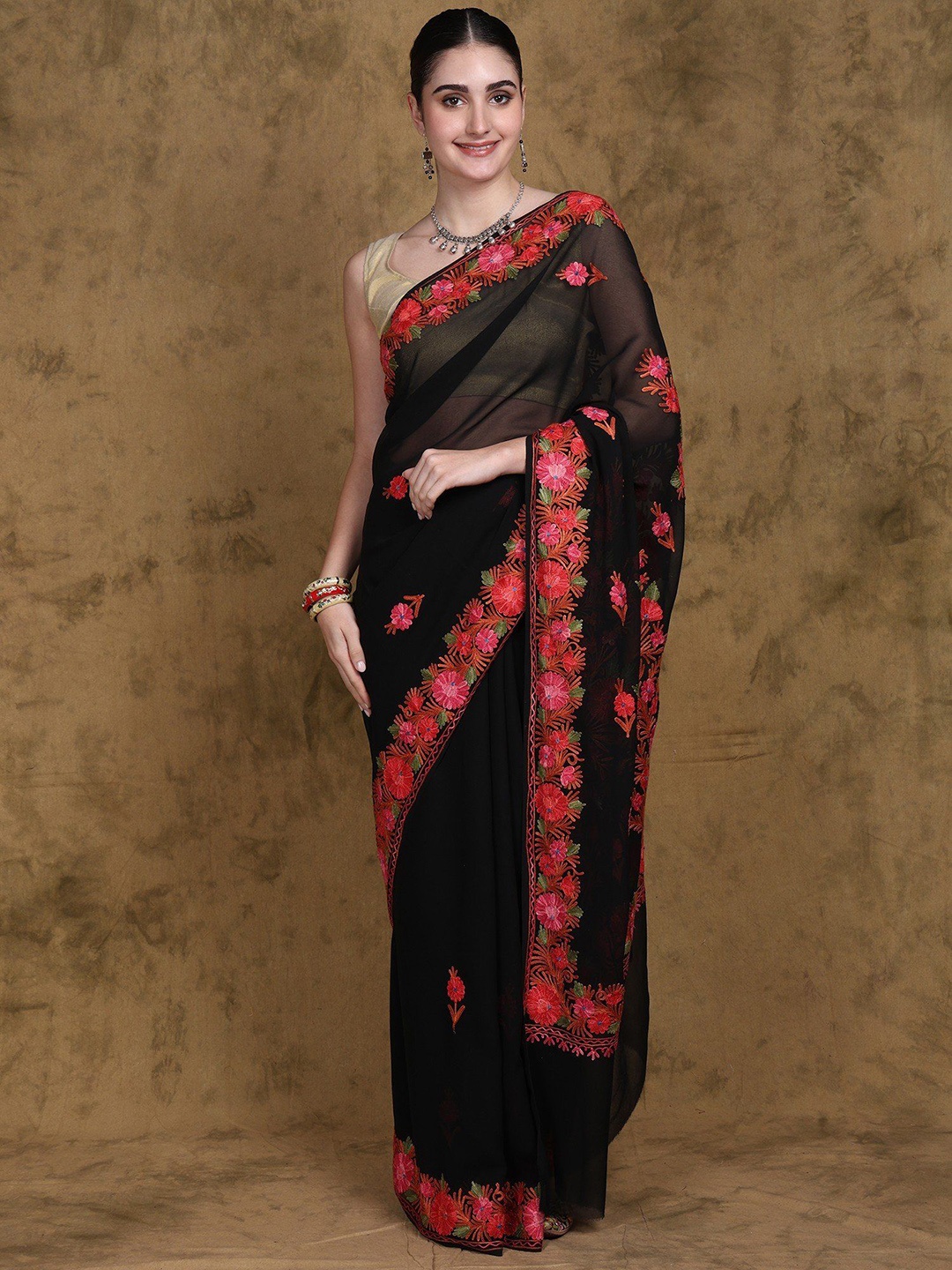 Exotic India Black Oyster Georgette Kashmiri Saree with Aari Embroidered Multicolor Flower
Exotic India Black Oyster Georgette Kashmiri Saree with Aari Embroidered Multicolor Flower