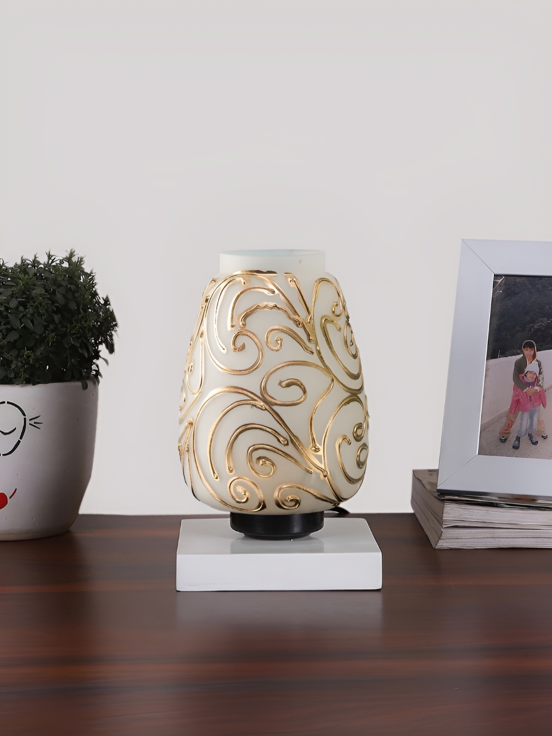 Devansh White & Gold-Toned Textured Abstract Shaped Glass Table Lamp With Wooden Base
Devansh White & Gold-Toned Textured Abstract Shaped Glass Table Lamp With Wooden Base