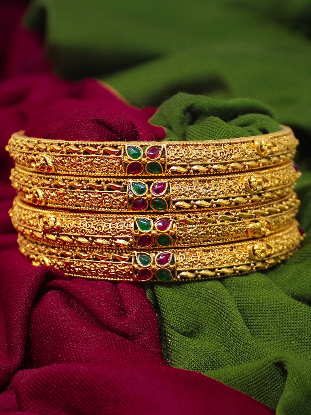 NAGNESHI ART Set Of 4 Gold-Plated Floral Ruby Stones-Studded Traditional Temple Bangles
NAGNESHI ART Set Of 4 Gold-Plated Floral Ruby Stones-Studded Traditional Temple Bangles