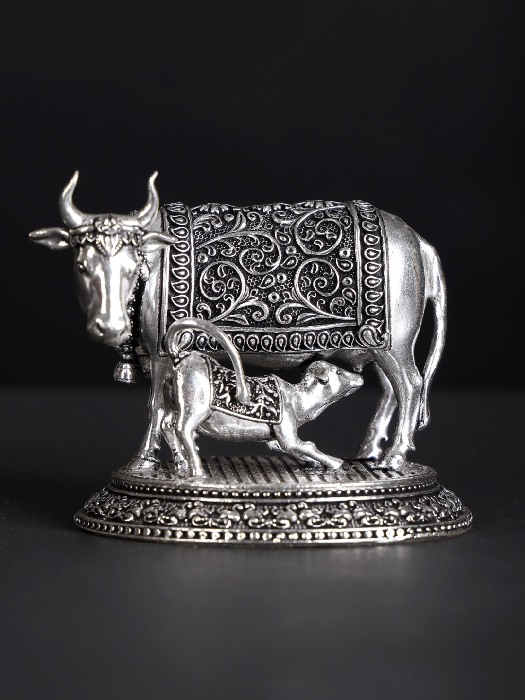 Exotic India Silver-Toned Cow and Calf Silver-Plated Brass Religious Figurine Showpiece
Exotic India Silver-Toned Cow and Calf Silver-Plated Brass Religious Figurine Showpiece