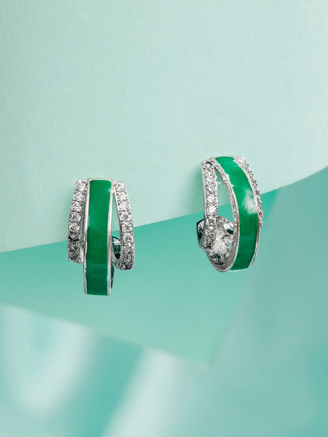SARAF TRENDZ Silver-Plated American Diamond Studded Oval Shaped Studs Earrings, Green
SARAF TRENDZ Silver-Plated American Diamond Studded Oval Shaped Studs Earrings, Green