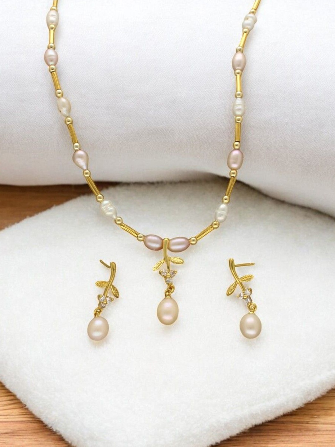 Sri Jagdamba Pearls Dealer Gold Plated CZ Stone Studded & Beaded Necklace and Earrings
Sri Jagdamba Pearls Dealer Gold Plated CZ Stone Studded & Beaded Necklace and Earrings