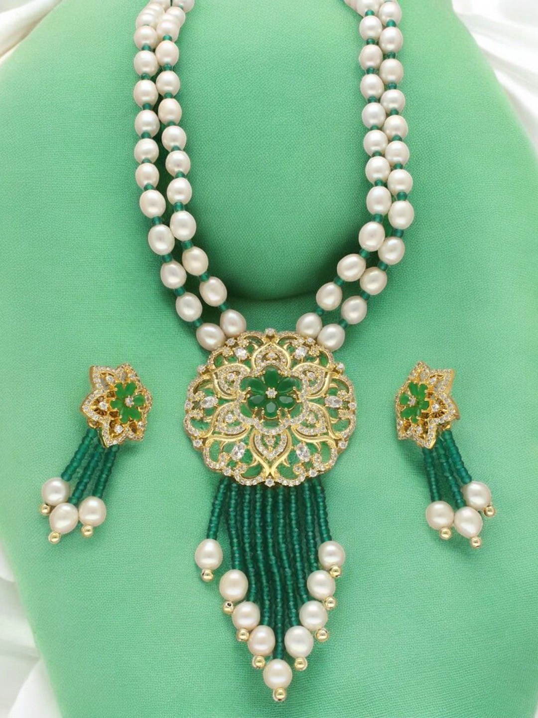 Sri Jagdamba Pearls Dealer Gold Plated CZ Stone Studded & Beaded Necklace and Earrings
Sri Jagdamba Pearls Dealer Gold Plated CZ Stone Studded & Beaded Necklace and Earrings