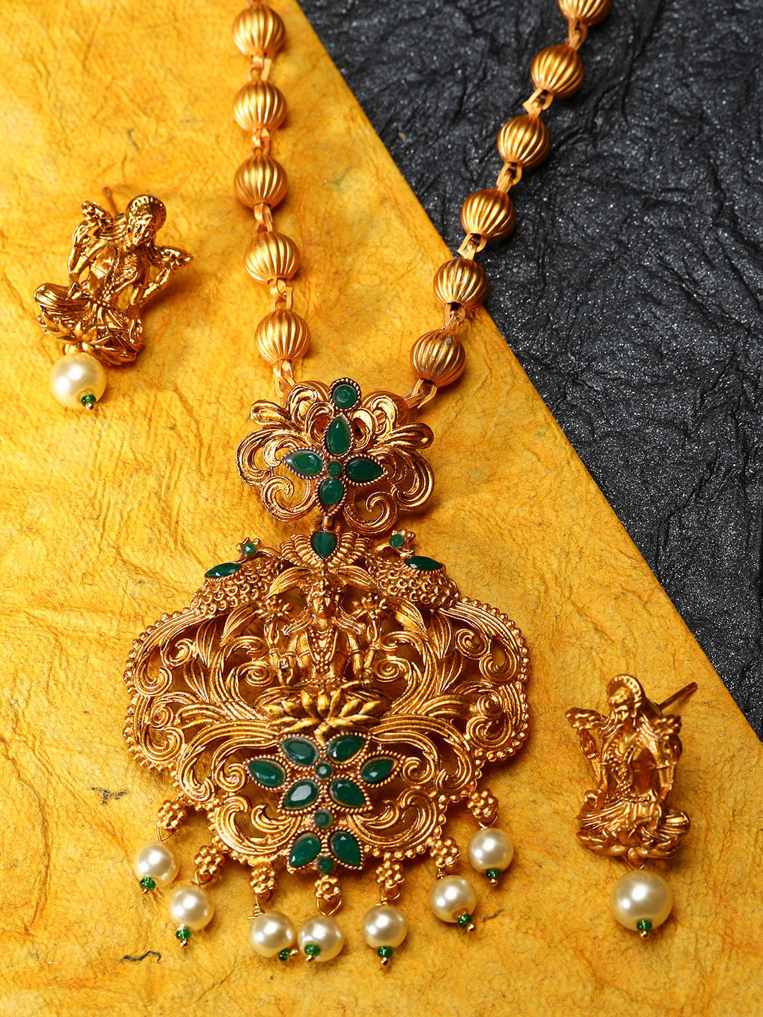 ANIKAS CREATION Gold-Plated & Green Stone-Studded Beaded Maa Laxmi Temple Jewellery Set 
ANIKAS CREATION Gold-Plated & Green Stone-Studded Beaded Maa Laxmi Temple Jewellery Set