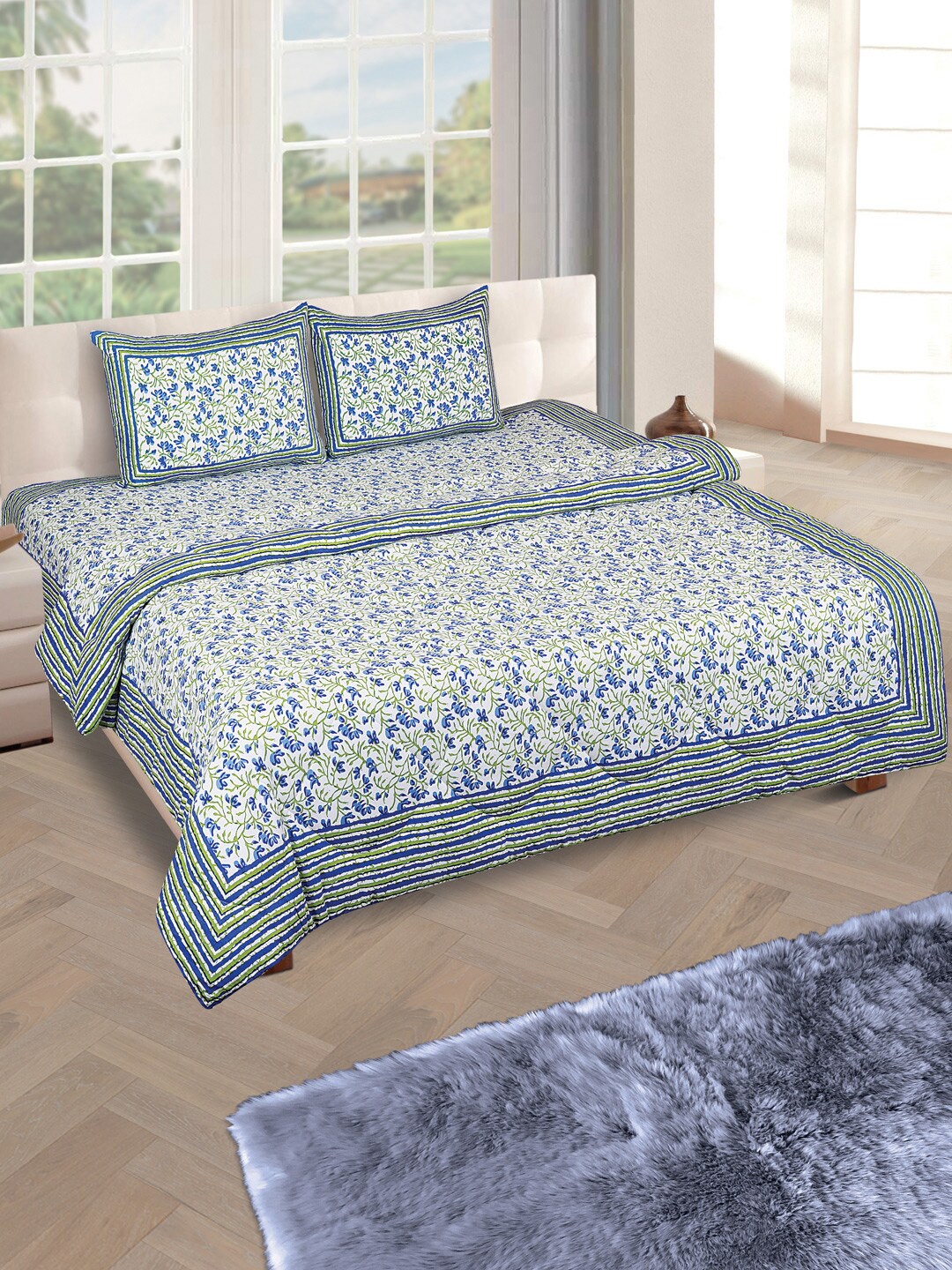 ROMEE Off-White & Blue Printed Reversible Quilt with King Size Bedsheet & 2 Pillow Covers
ROMEE Off-White & Blue Printed Reversible Quilt with King Size Bedsheet & 2 Pillow Covers
