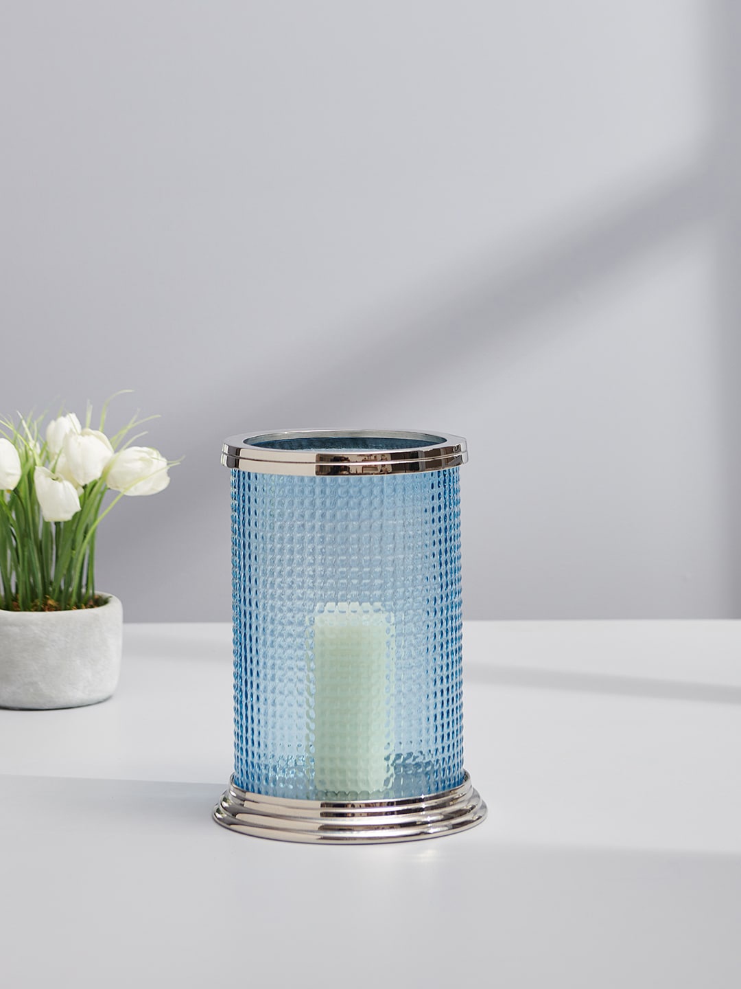 Pure Home and Living Silver-Toned & Blue Textured Glass Cylindrical Hurricane Candle Holder
Pure Home and Living Silver-Toned & Blue Textured Glass Cylindrical Hurricane Candle Holder
