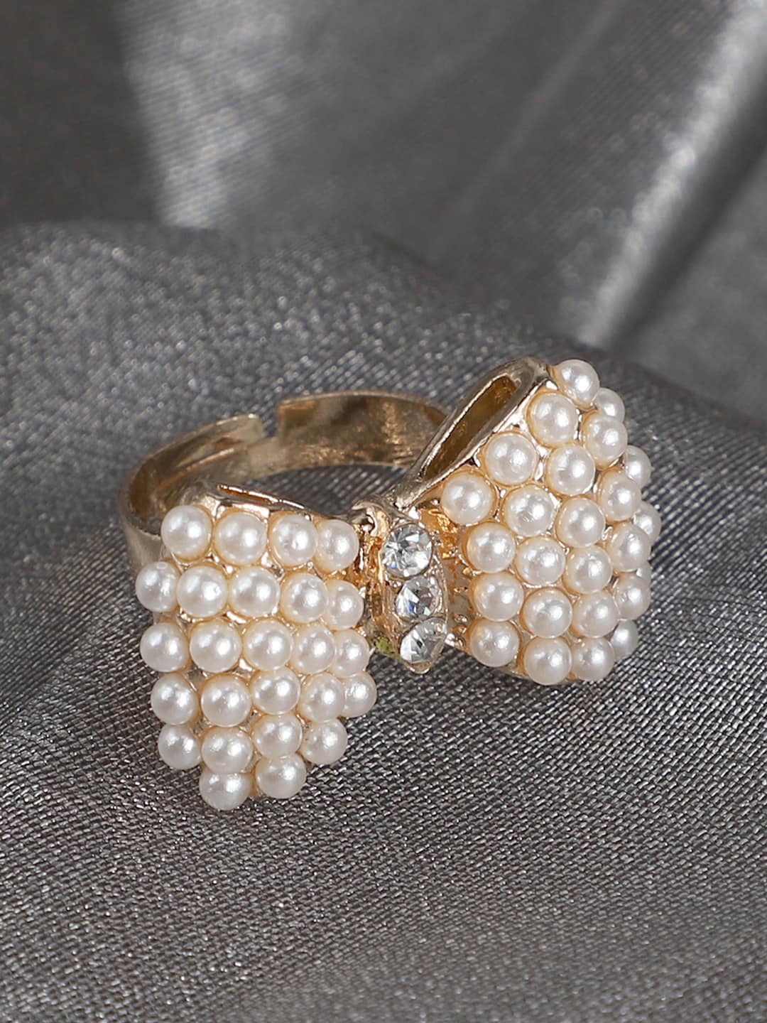 ANIKAS CREATION Gold-Plated White Stone & Pearl Studded Bow-Shape Adjustable Finger Ring
ANIKAS CREATION Gold-Plated White Stone & Pearl Studded Bow-Shape Adjustable Finger Ring