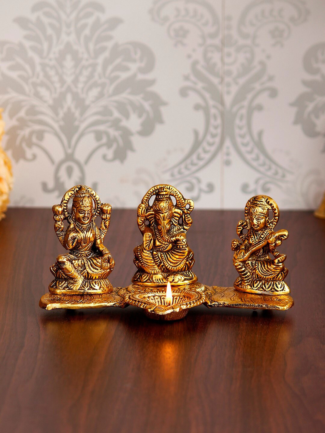 eCraftIndia Gold-Toned Laxmi Ganesha With Diya On Leaf Chowki Handcrafted Metal Decorative Showpiece
eCraftIndia Gold-Toned Laxmi Ganesha With Diya On Leaf Chowki Handcrafted Metal Decorative Showpiece
