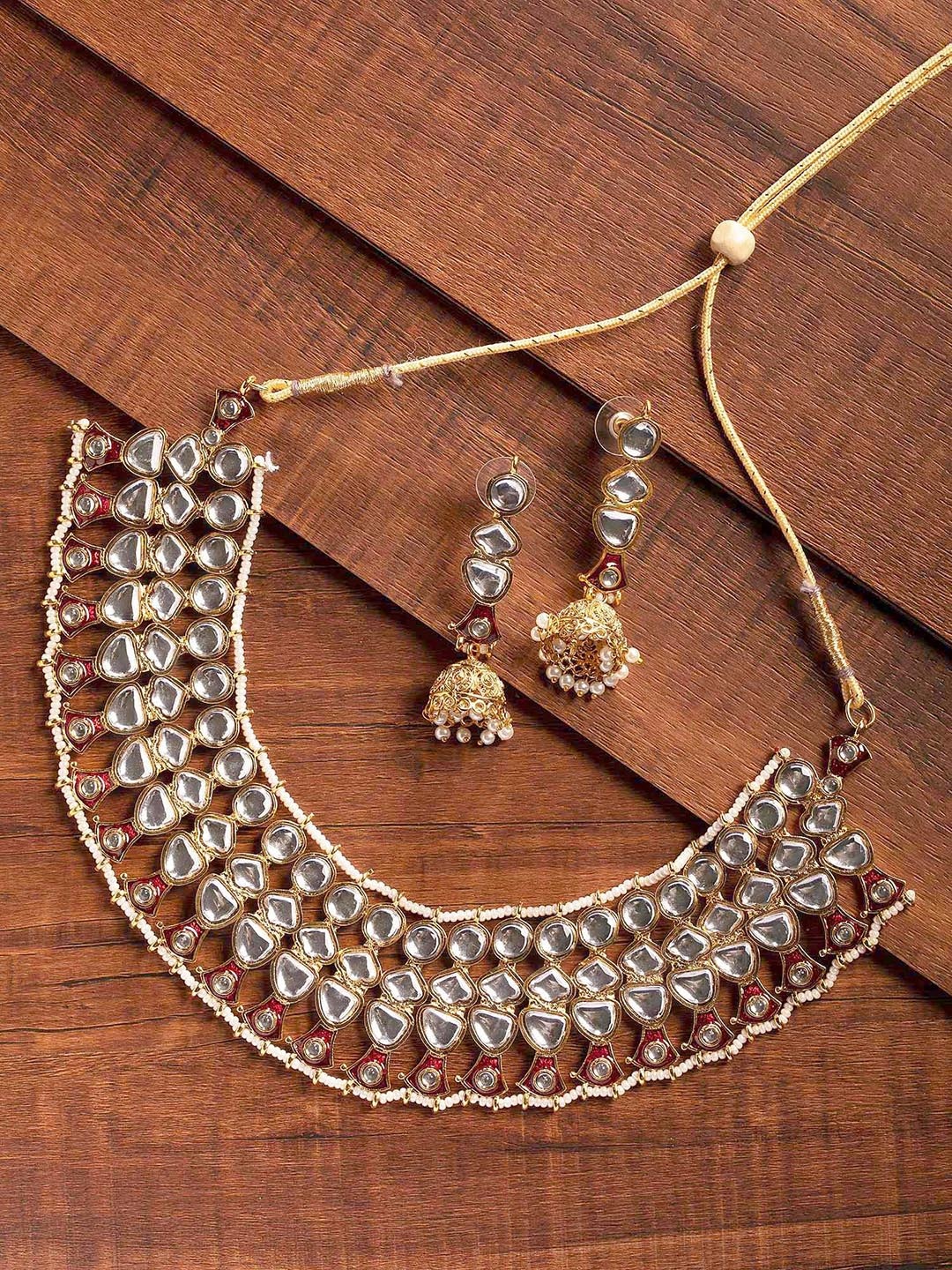 Zaveri Pearls Gold-Plated White & Red Kundan-Studded & Beaded Enamelled Jewellery set
Zaveri Pearls Gold-Plated White & Red Kundan-Studded & Beaded Enamelled Jewellery set