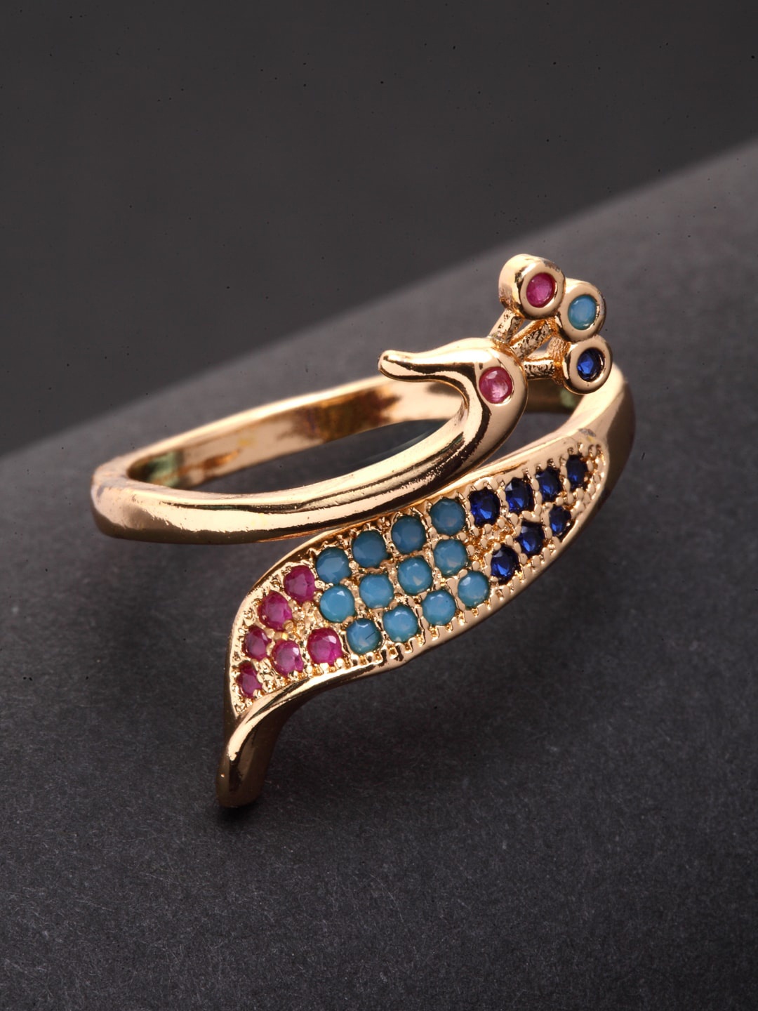 VOGUE PANASH Gold-Plated & Blue Zirconia Studded Peacock Shaped Adjustable Finger Ring
VOGUE PANASH Gold-Plated & Blue Zirconia Studded Peacock Shaped Adjustable Finger Ring