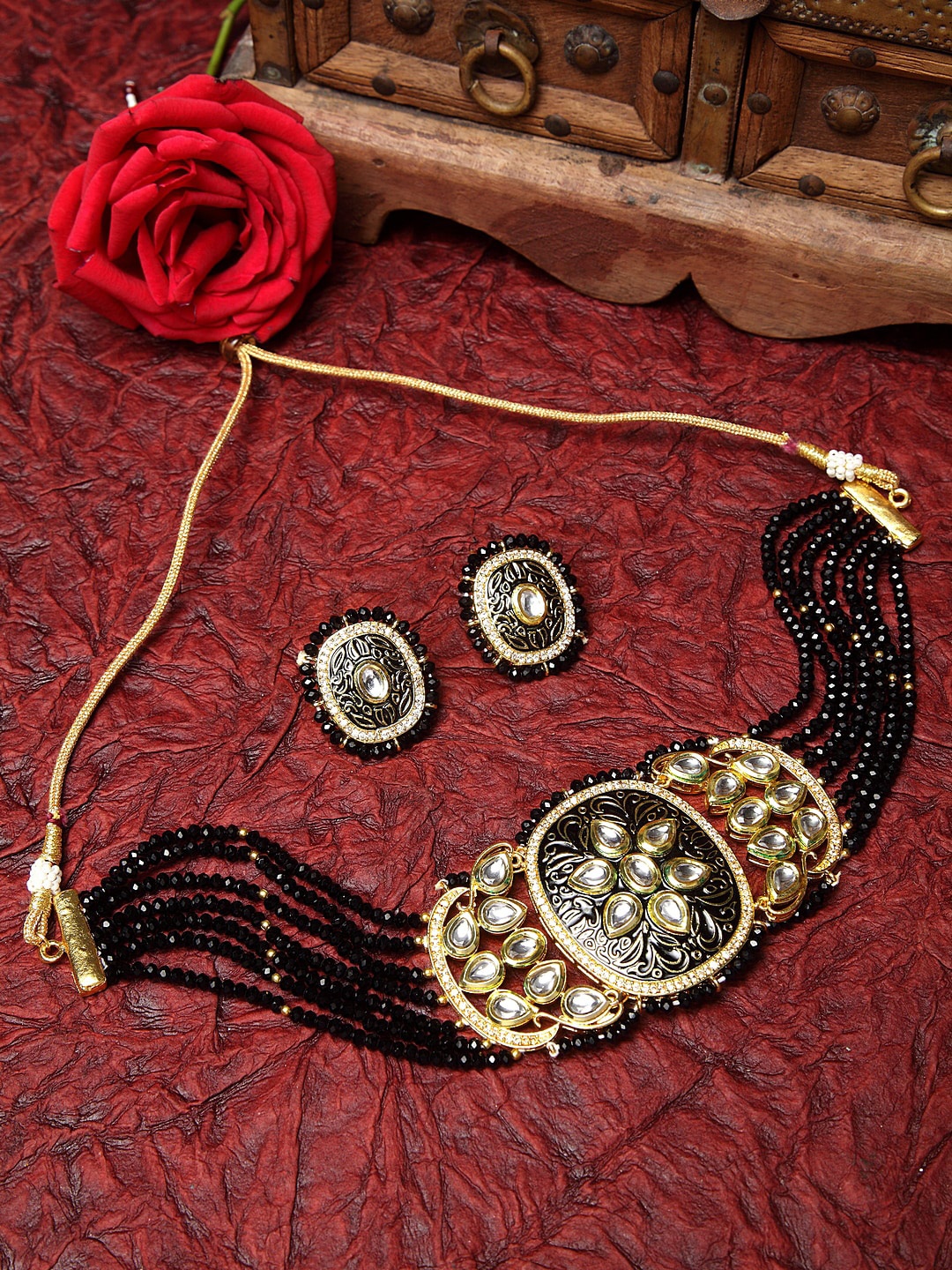 Moedbuille Gold-Plated Black Kundan Onyx Beaded Hand Painted Meenakari Jewellery Set
Moedbuille Gold-Plated Black Kundan Onyx Beaded Hand Painted Meenakari Jewellery Set