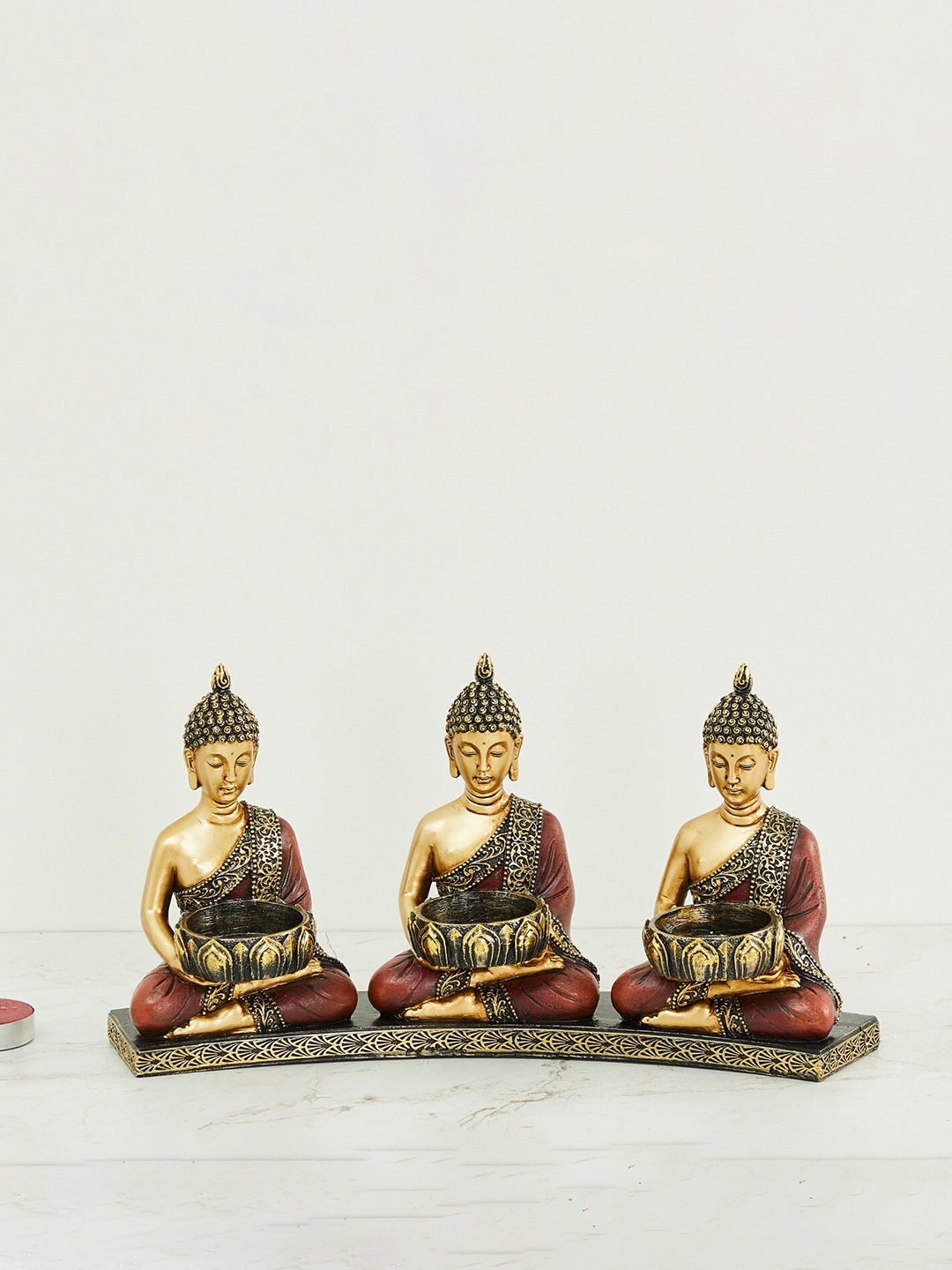 Home Centre Gold-Toned & Brown Polyresin Alpana Three Buddha Figurine With T-Light Holder Showpiece
Home Centre Gold-Toned & Brown Polyresin Alpana Three Buddha Figurine With T-Light Holder Showpiece