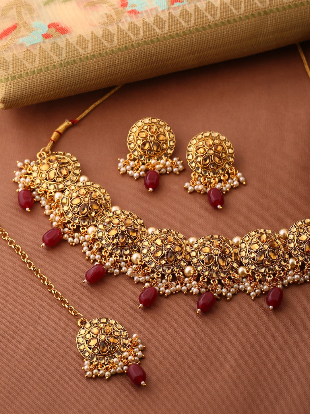Shoshaa Gold-Plated Red Artificial Stones & Beads-Studded Handcrafted Choker Jewellery Set
Shoshaa Gold-Plated Red Artificial Stones & Beads-Studded Handcrafted Choker Jewellery Set