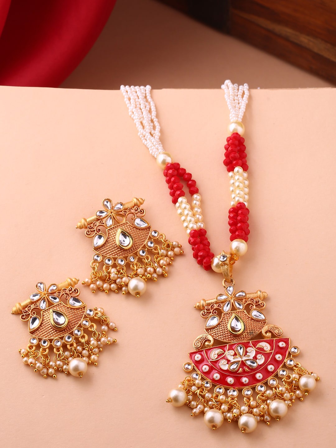 Shoshaa Gold-Plated Red & Off-White Stone-Studded & Beaded Hand Painted Jewellery Set
Shoshaa Gold-Plated Red & Off-White Stone-Studded & Beaded Hand Painted Jewellery Set