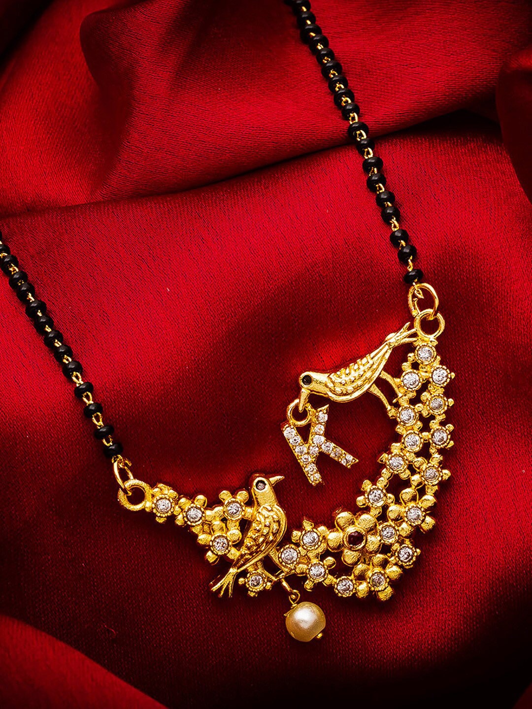 aadita Gold-Plated Black & White AD-Studded & Beaded Alphabet Initials Letter K Mangalsutra
aadita Gold-Plated Black & White AD-Studded & Beaded Alphabet Initials Letter K Mangalsutra