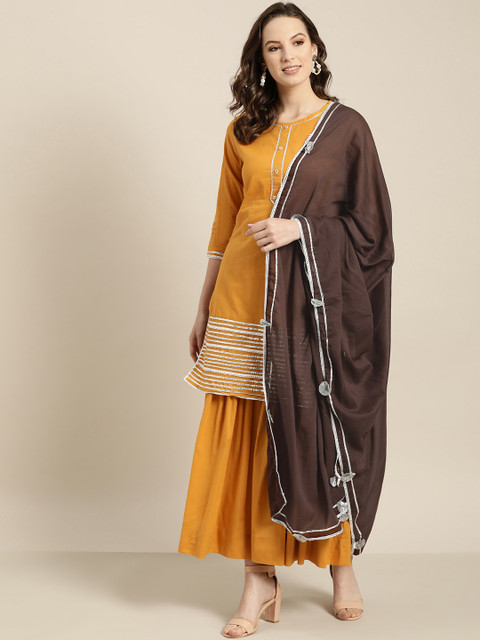 Sangria Women Mustard Yellow & Brown Solid Straight Kurta with Sharara & Dupatta
Sangria Women Mustard Yellow & Brown Solid Straight Kurta with Sharara & Dupatta