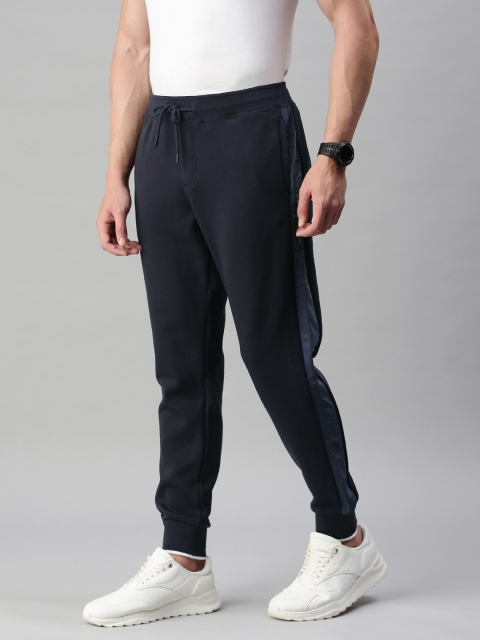 Tommy Hilfiger Men Navy Blue Solid Straight Fit TH Flex Nylon Paneled Joggers
Tommy Hilfiger Men Navy Blue Solid Straight Fit TH Flex Nylon Paneled Joggers
