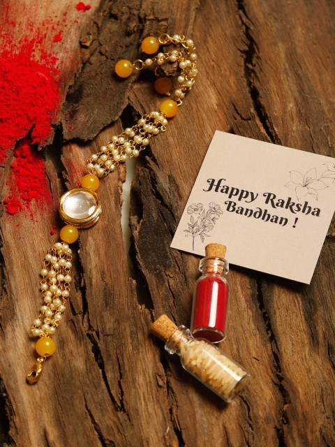 Ruby Raang Yellow & Gold Kundan Beaded Rakhi Gift Box With Roli, Chawal & Greeting Card
Ruby Raang Yellow & Gold Kundan Beaded Rakhi Gift Box With Roli, Chawal & Greeting Card
