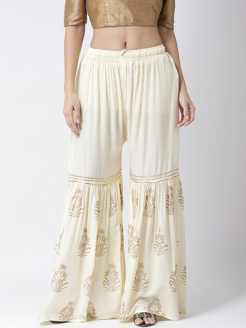 Charitra Women Off White & Gold-Toned Ethnic Motifs Printed Ruffle Flared Palazzos
Charitra Women Off White & Gold-Toned Ethnic Motifs Printed Ruffle Flared Palazzos