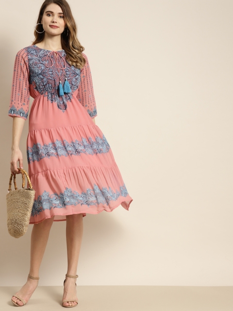 Juniper Peach Pink & Blue Ethnic Motifs Print Tie-Up Neck Pleated Tiered Georgette Dress
Juniper Peach Pink & Blue Ethnic Motifs Print Tie-Up Neck Pleated Tiered Georgette Dress