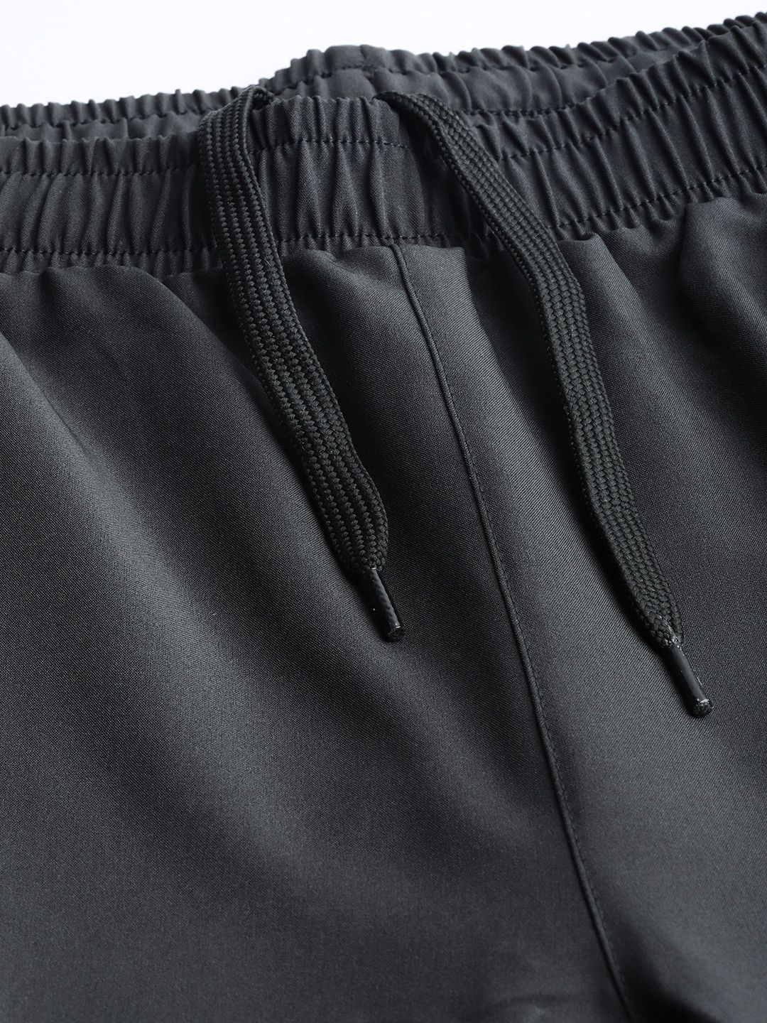 Elastic track pants waistband and drawcord detail