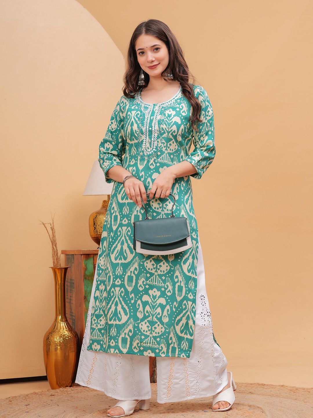 Sleeveless straight cotton kurta with cutwork neckline and mirror work paired with palazzo