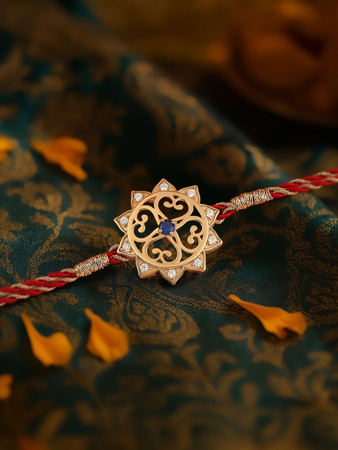 Ornate Jewels 18K Gold Plated Blue Cubic Zirconia Swastik Rakhi With Roli Chawal-image-45