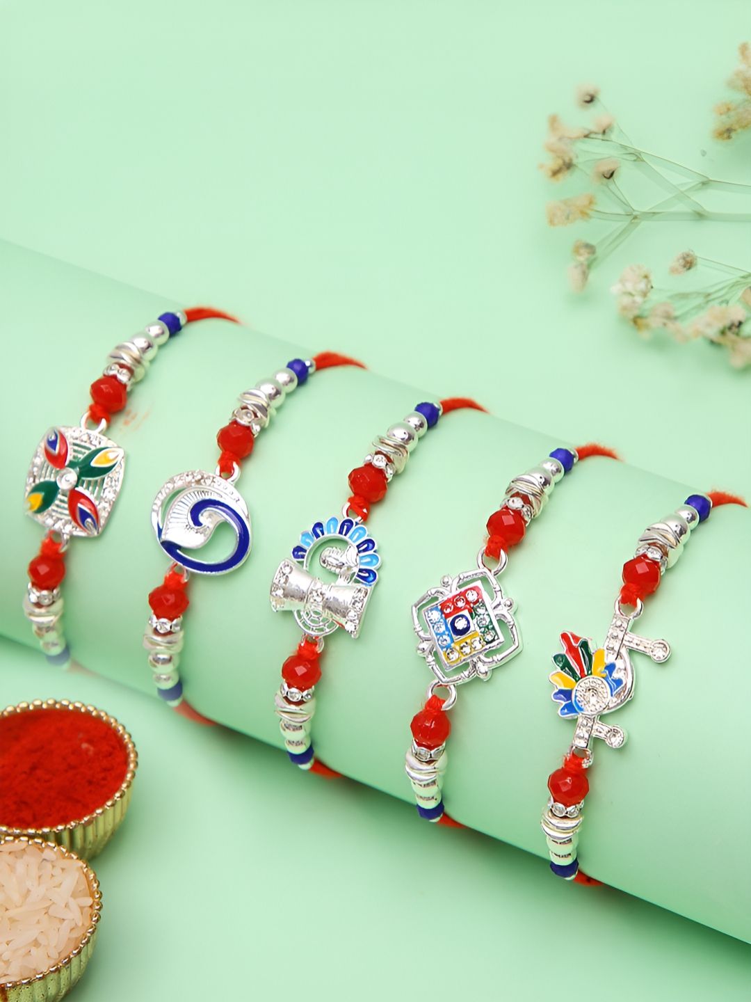 Myntra Elegant Homes Set Of 5 Silver-Plated Rakhis With Greeting Card & Roli Chawal-image-24