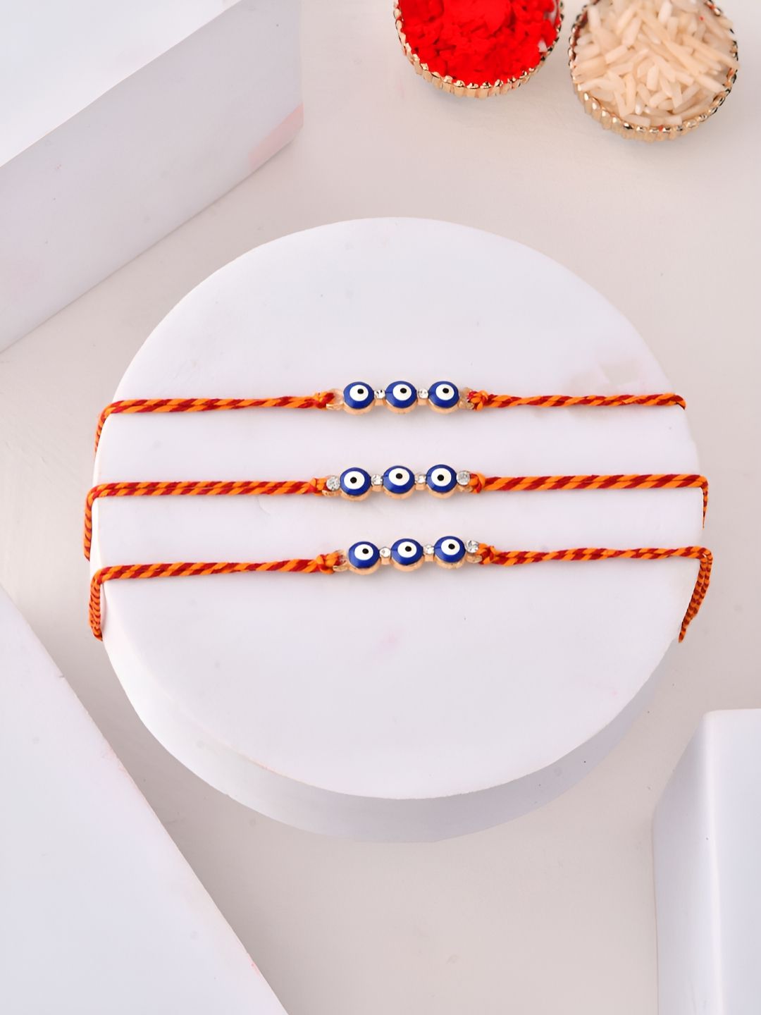 Myntra Elegant Homes Set Of 3 Evil Eye Beaded Rakhis With Greeting Card & Roli Chawal-image-27