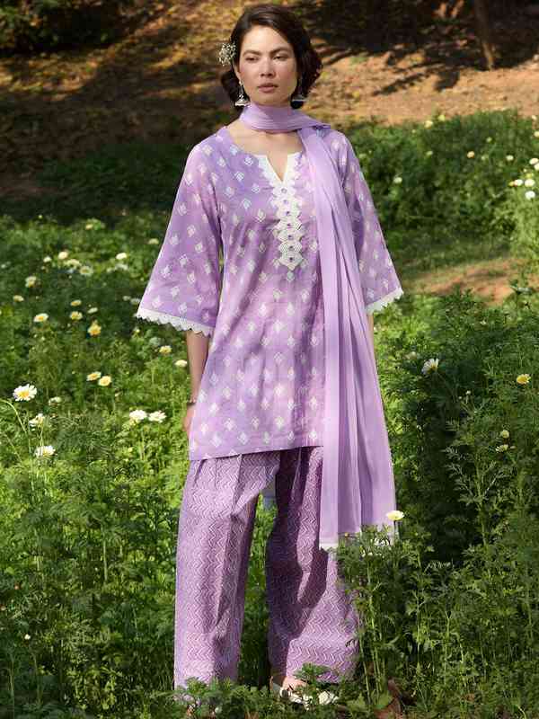 Portrait of a woman in traditional Punjabi attire at night, exuding elegance and cultural pride.