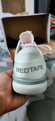 red tape white shoe